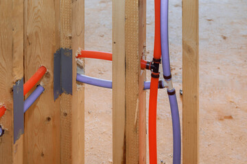Pvc plastic red and blue piping water system integration in a new home construction