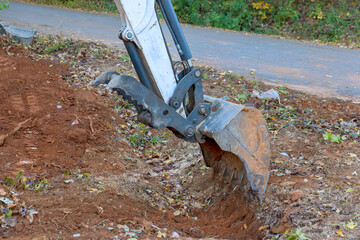 Digging ditch with tractor to accommodate drainage concrete sewage a pipe