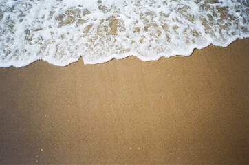 Waves on sand in 35mm