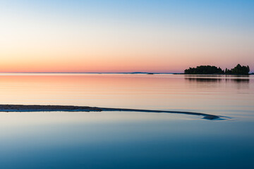 Tranquil Sunrise over Reflection on Lake Vänern's Shore