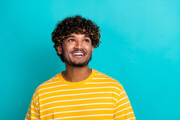 Photo portrait of nice young male look cheerful empty space dressed stylish striped yellow garment isolated on cyan color background