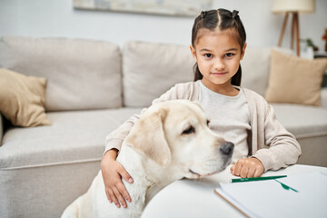 happy girl in casual clothes drawing and hugging labrador in modern living room, art and leisure