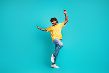 Fototapeta na wymiar Full body photo of cheerful overjoyed person raise hands chilling dancing isolated on teal color background