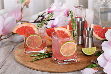 Refreshing organic cocktail with grapefruit slice, lime and rosemary sprig in a glass