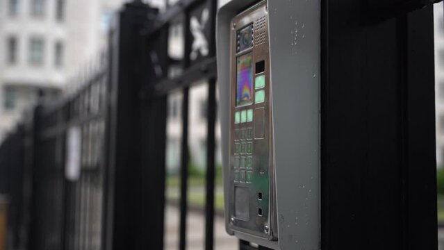 video intercom. A woman's hand dials the code for an intercom call