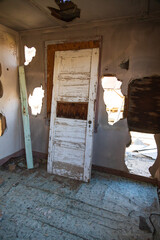 Old white wooden door in abandoned building