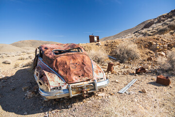 Old rusted out car in the desert