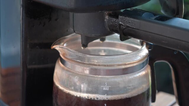 Coffee machine with garden view on background