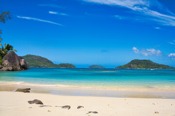Fototapeta na wymiar Sunny, white sandy beach, turquoise water at port glaud beach, Mahe, Seychelles. 4.