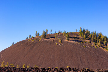 Large volcanic cinder cone seen from highway 97 in eastern Oregon, USA
