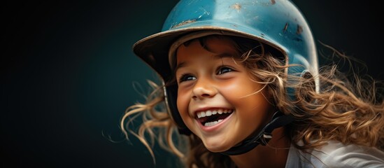In the summer heat a happy child with blue eyes and a contagious smile wore a baseball helmet protecting their beautiful hair as they played a game of baseball The portrait captured their jo - obrazy, fototapety, plakaty