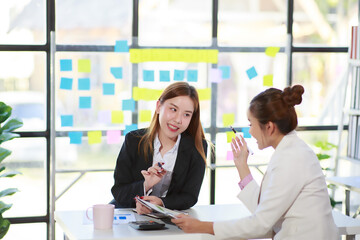 Happy Asian smiling business women working together in office