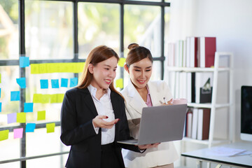 Happy Asian smiling business women working together in office