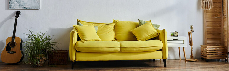 object photo of big yellow couch in vibrant spacious living room by wall with paintings, banner