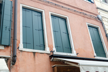 Fototapeta na wymiar Closed windows on a typical Venetian residential house - detail