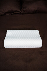 Physiotherapy concept. Orthopedic pillow on bed.