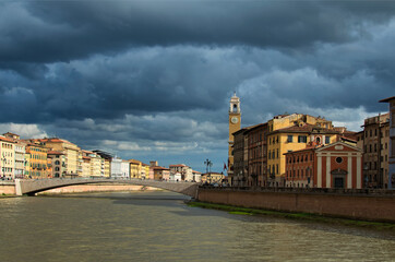 Picturesque panoramic landscape of medieval Pisa. Solferino bridge over Arno river. Colorful vintage buildings along embankment. Downtown of Pisa. Typical architecture of Tuscany region, Italy