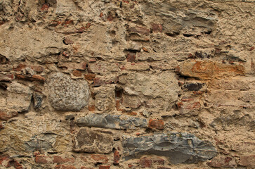 Detailed view of an ancient brick wall. Grunge stone wall background. Background of old vintage brick wall. Outdoor and indoor interiors. Background of stone wall texture Pisa, Italy
