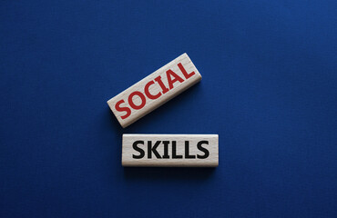 Social skills symbol. Wooden blocks with words Social skills Beautiful deep blue background. Business and Social skills concept. Copy space.