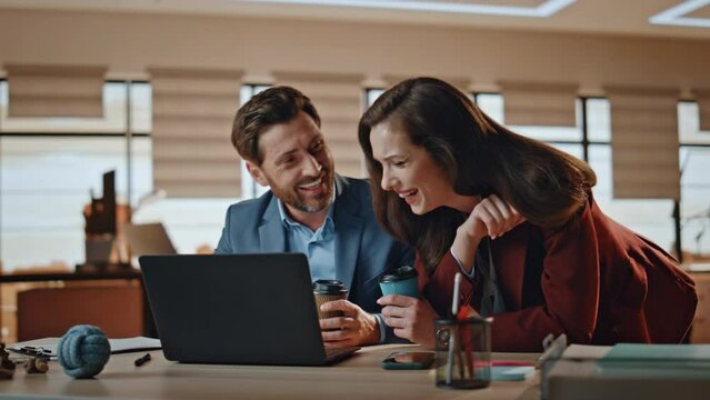 Business couple discussing computer screen at office closeup. Woman man laughing