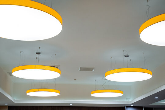 Office lighting with round lamps on the ceiling, lamp design, LED lighting. The chandelier is rounded.