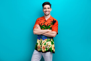 Photo of funny young guy folded hands summer print shirt confident tourist relaxing abroad model...