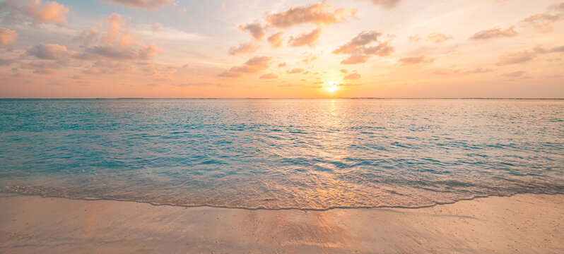 Closeup sea waves beach horizon. Panoramic beach landscape. Paradise tropical beach summer seascape. Colorful sunset sky, soft sand, calmness, tranquil relaxing sunlight. Inspire meditation vacation