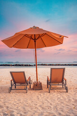 Romantic beach landscape. Couple chairs umbrella sunset sunrise colorful sky clouds. Dream beach honeymoon vacation. Best love destination travels. Amazing leisure relax wellbeing idyllic sunlight
