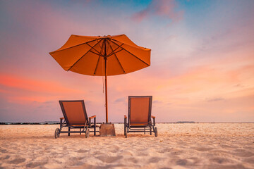 Romantic beach landscape. Couple chairs umbrella sunset sunrise colorful sky clouds. Dream beach honeymoon vacation. Best love destination travels. Amazing leisure relax wellbeing idyllic sunlight