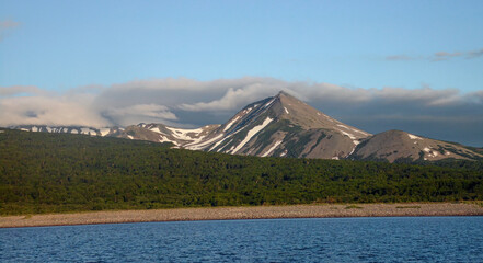 Fototapeta premium Peninsula Kamchatka Landscape. Small Snowy Mountains and Hills