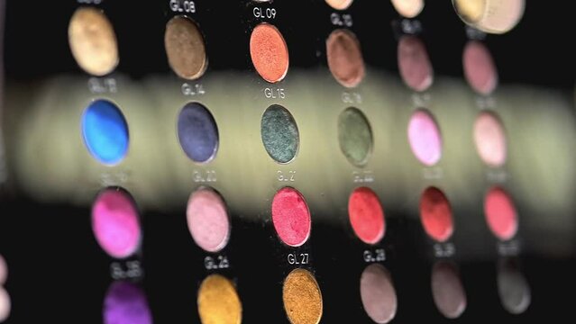 Professional makeup eyeshadow palette. Multicolor glitter eyeshadow and professional makeup eye shadow palette for beauty shots. A huge palette of colorful shadows for professional makeup artists. 