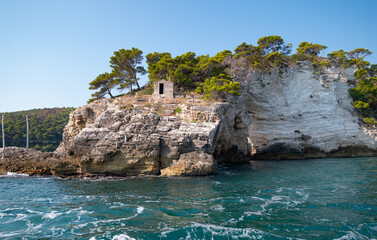 Fototapeta na wymiar view from the boat of the famous rock caves of the Gargano coast
