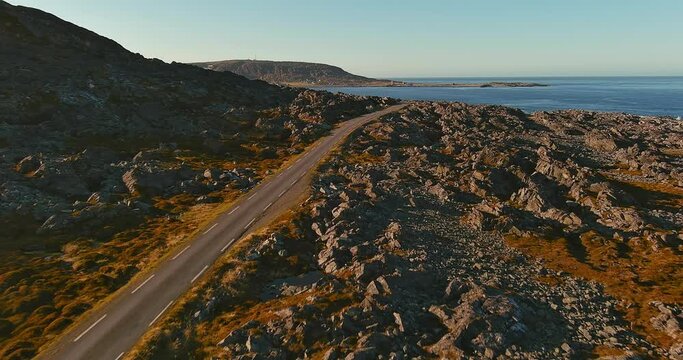 Aerial view of coast road 8100 to Hamningberg with rocky landscape in sunny summer weather, Varanger Peninsula, Norway.