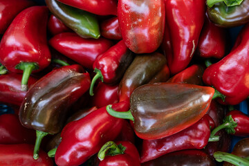 detail of mature reddish colors. Texture of many bell peppers harvested in the market