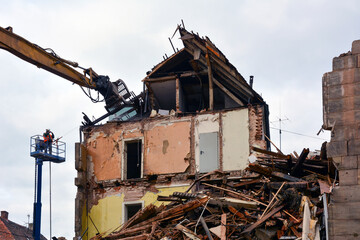 Dismantling and demolition of an old house with an excavator