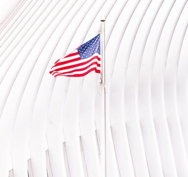 New York, USA: US flag against the white background of Oculus Terminal