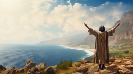 Old prophet with beard prays smiling with widely spread arms raised to sky standing on hill by lake