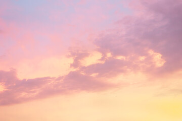 Majestic dusk. Sunset sky twilight in the evening with colorful sunlight. Pastel colors. Abstract nature background. Moody pink, purple and yellow clouds sunset sky. - obrazy, fototapety, plakaty