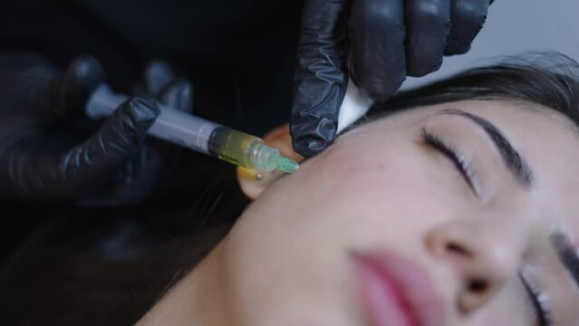 Face of a beautiful woman receiving prp injection