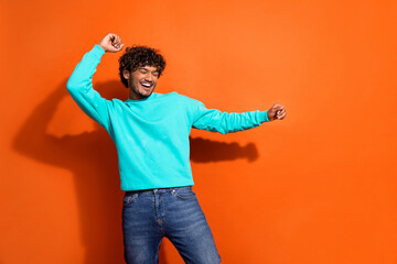 Portrait of nice overjoyed person dancing partying have fun empty space isolated on orange color background