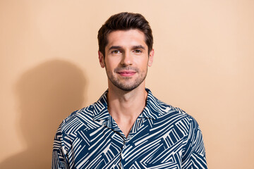 Portrait of positive optimistic nice guy with trendy hairstyle wear stylish shirt look at camera isolated on beige color background