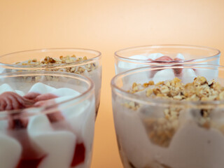 Ice cream on a bright orange background. Ice cream in a plastic cup on an orange background.