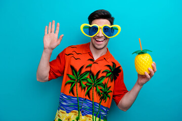 Photo of good mood man with stylish hairdo dressed print shirt in funny glasses hold ananas drink...