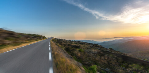 Mediterranean sea coast road into mountains horizon in summer with beautiful bright sun rays