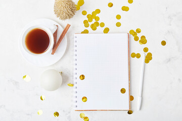 Scene with coffee cup, confetti, and notepad mock-up for a resolutions, for spirited new year