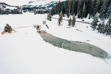 A frozen mountain lake with a dam for water energy