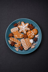 Beautiful Christmas gingerbread cookies of different colors on a ceramic plate