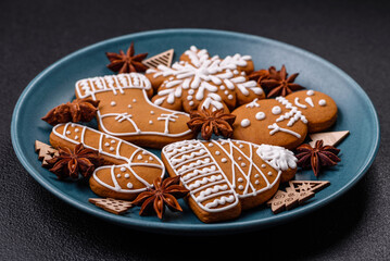 Beautiful Christmas gingerbread cookies of different colors on a ceramic plate