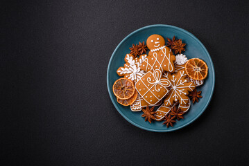 Beautiful Christmas gingerbread cookies of different colors on a ceramic plate