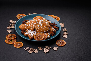 Beautiful Christmas gingerbread cookies of different colors on a ceramic plate